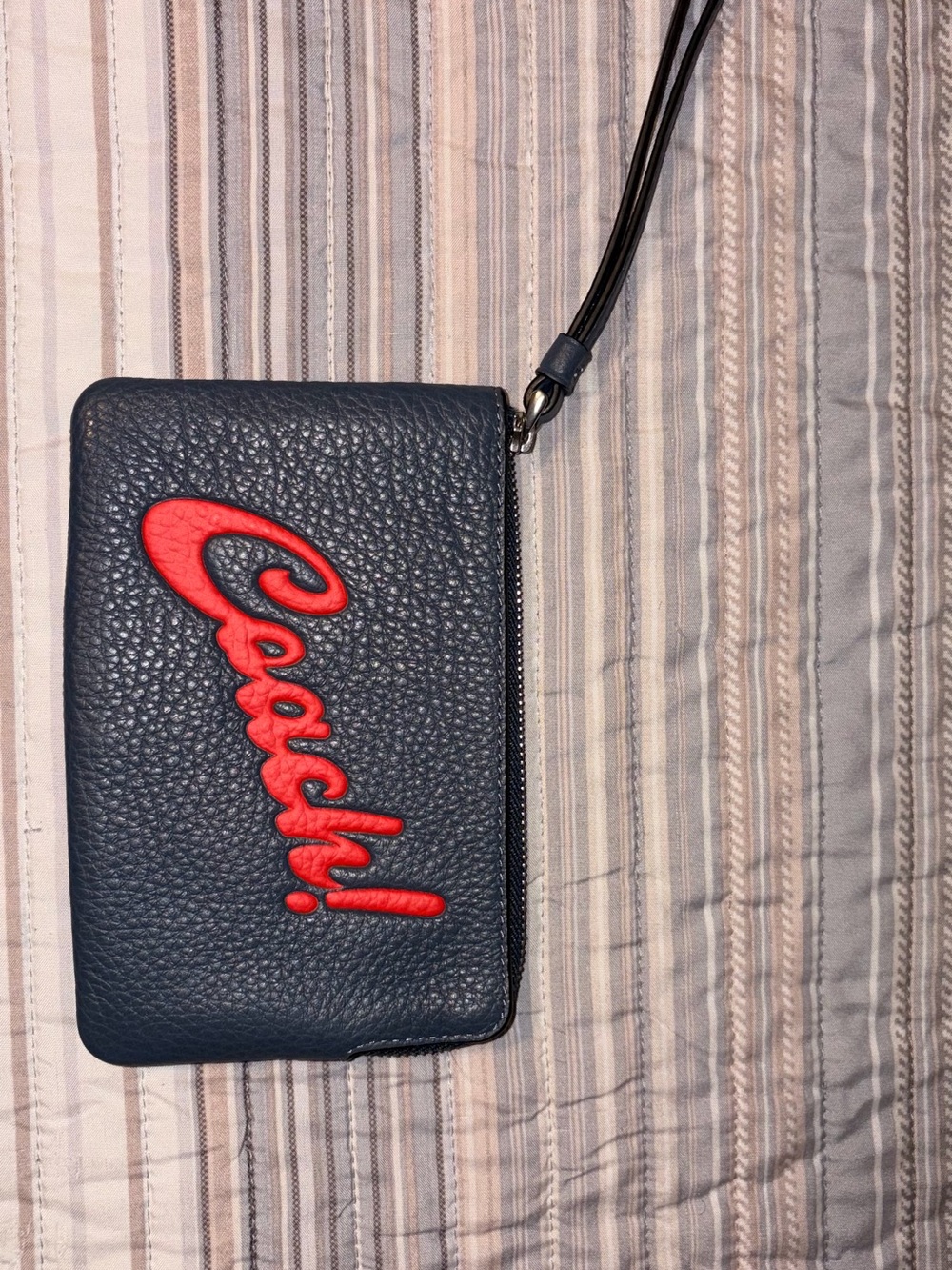 Coach Navy Pebbled Leather Wristlet with Red Script Logo